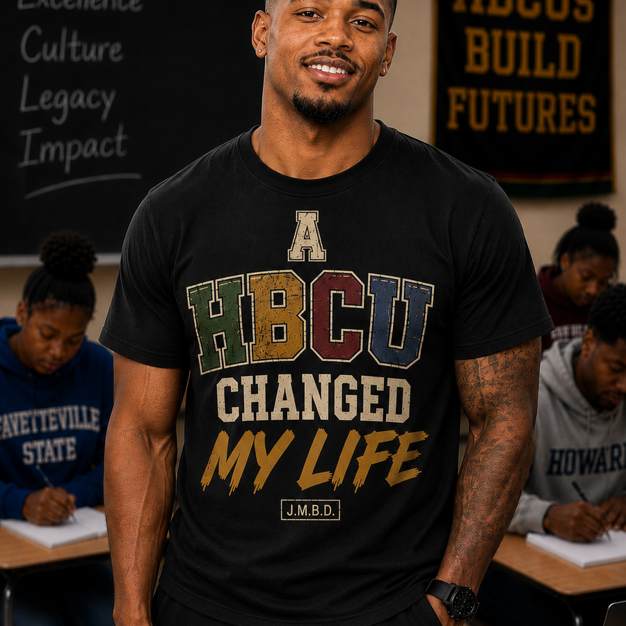 Man wearing the A HBCU Changed My Life tee by Just My Baby Daddy, varsity HBCU lettering in green, gold, maroon and navy on black